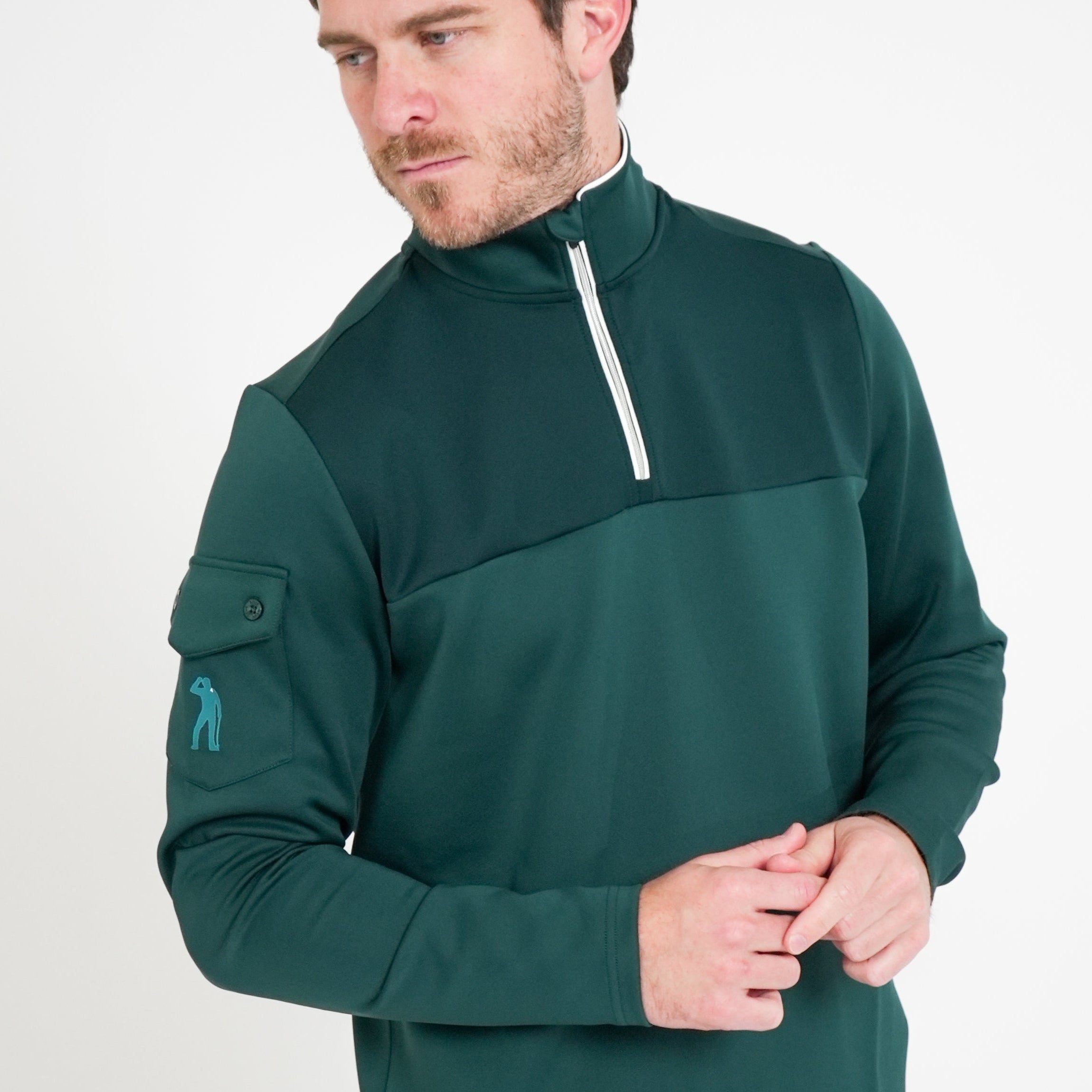 Man wearing a green pullover with a white zipper on a light gray background